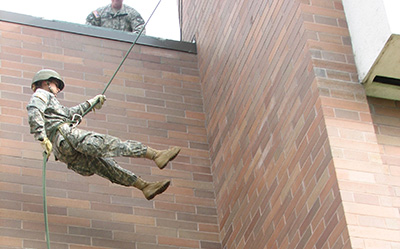 A student repelling for an exercise
