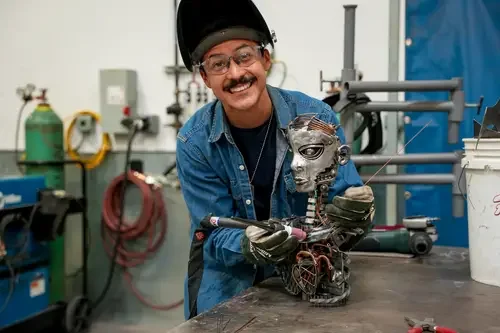 Welding student, Frank Ramirez, with his welded art statue