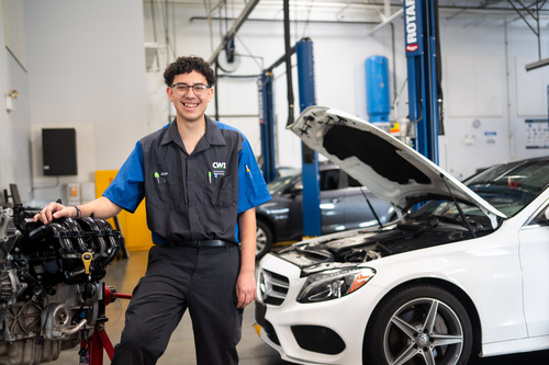 A mechanic stands in an auto repair shop