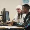 Two students working at desktop computers