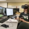 Drafting student with virtual headset on in front of computer