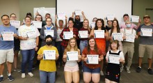 Andrea Schumaker's Fermentation 120 class holding their 'My Why for CWI' signs