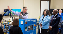 A professor demonstrates technology to onlooking visitors to College of Western Idaho's Mechatronics program.