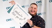 Graduate holding sign that reads, "CWI empowered me to graduate and not give up!"