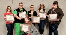 Faculty and staff pose with their awards against a wall at the CWI Innovation in Action event.