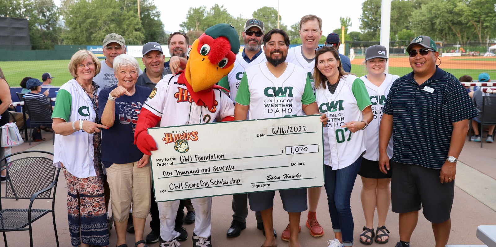 Humphrey the Hawks presents a check to CWI leadership, donors, and Board members for the SCORE Big Scholarship