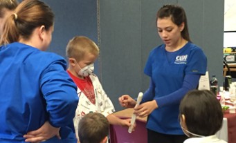 Dental Assisting students demonstration with kids.