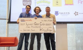 Lower Gear Cycles team accepting prize money on state at Idaho Entrepreneur Challenge