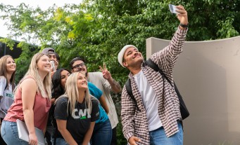 Students taking a selfie together on campus