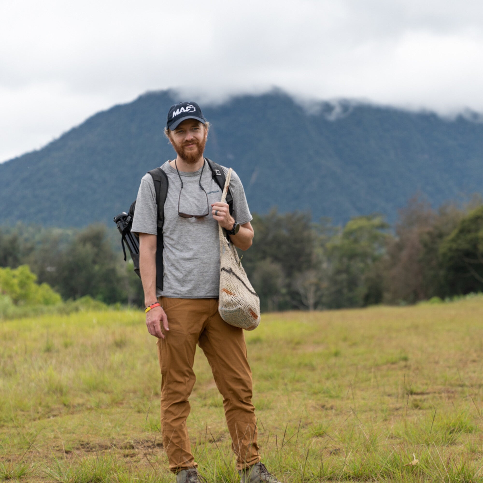 A photographer stands in a field.