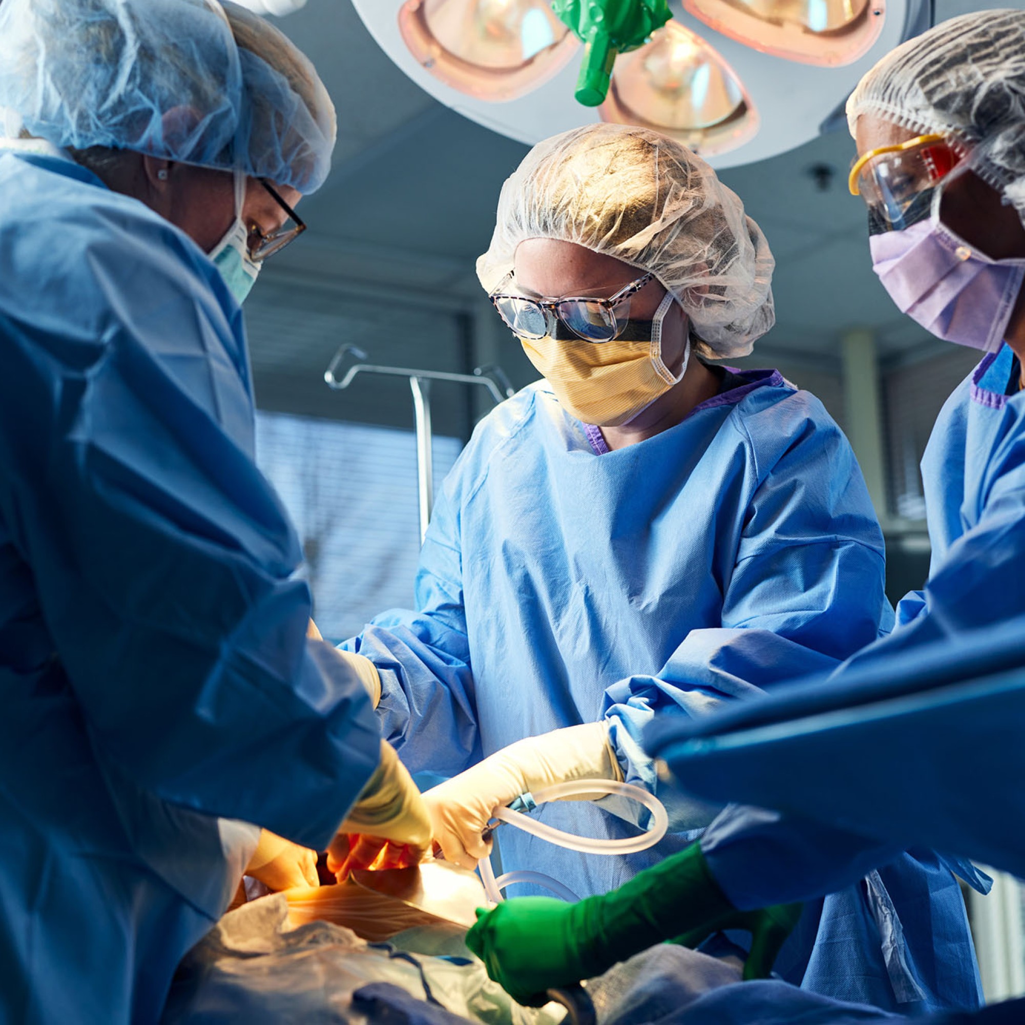 Surgical technicians assist during a medical surgical procedure.
