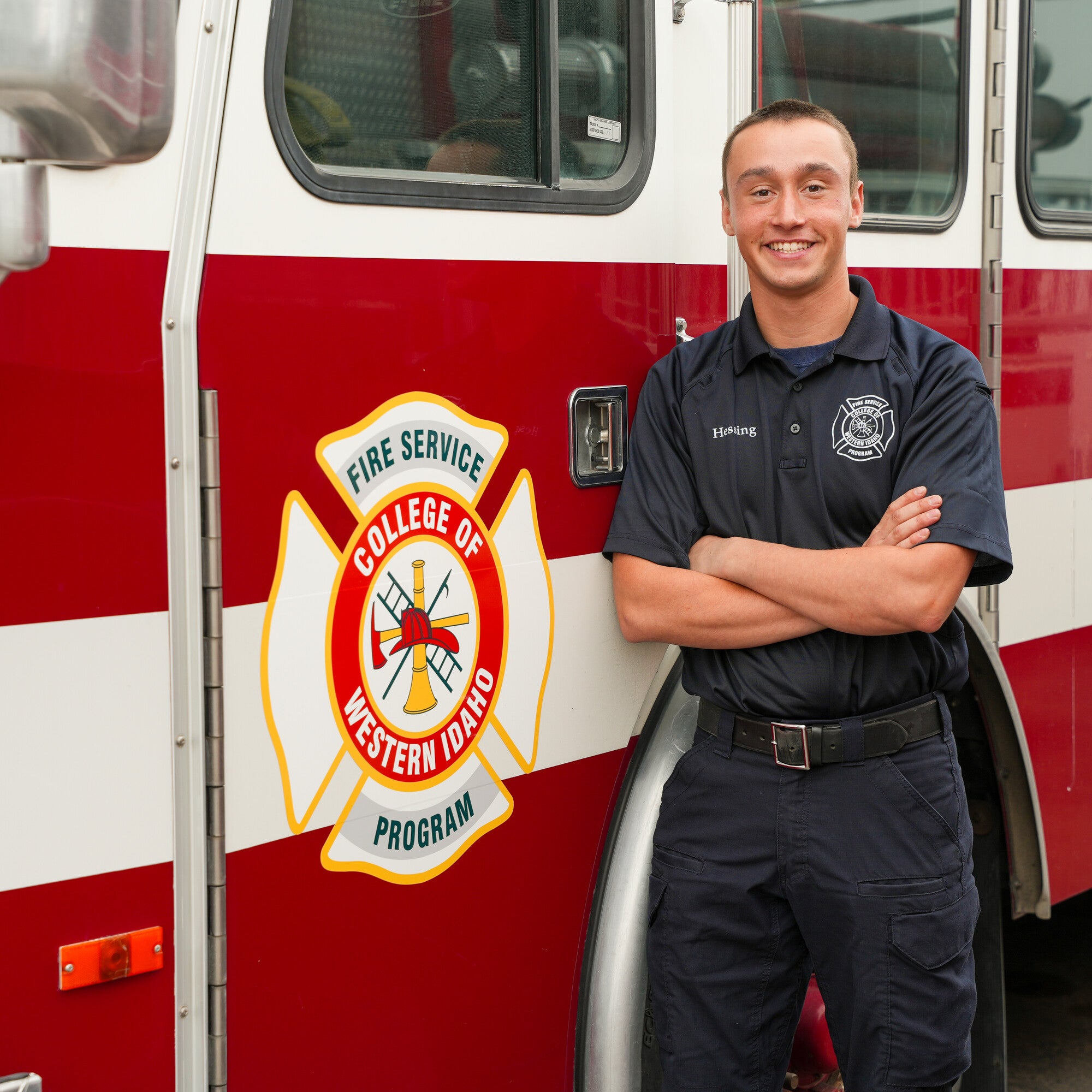 Kemper Hessing stands in front of a CWI fire truck