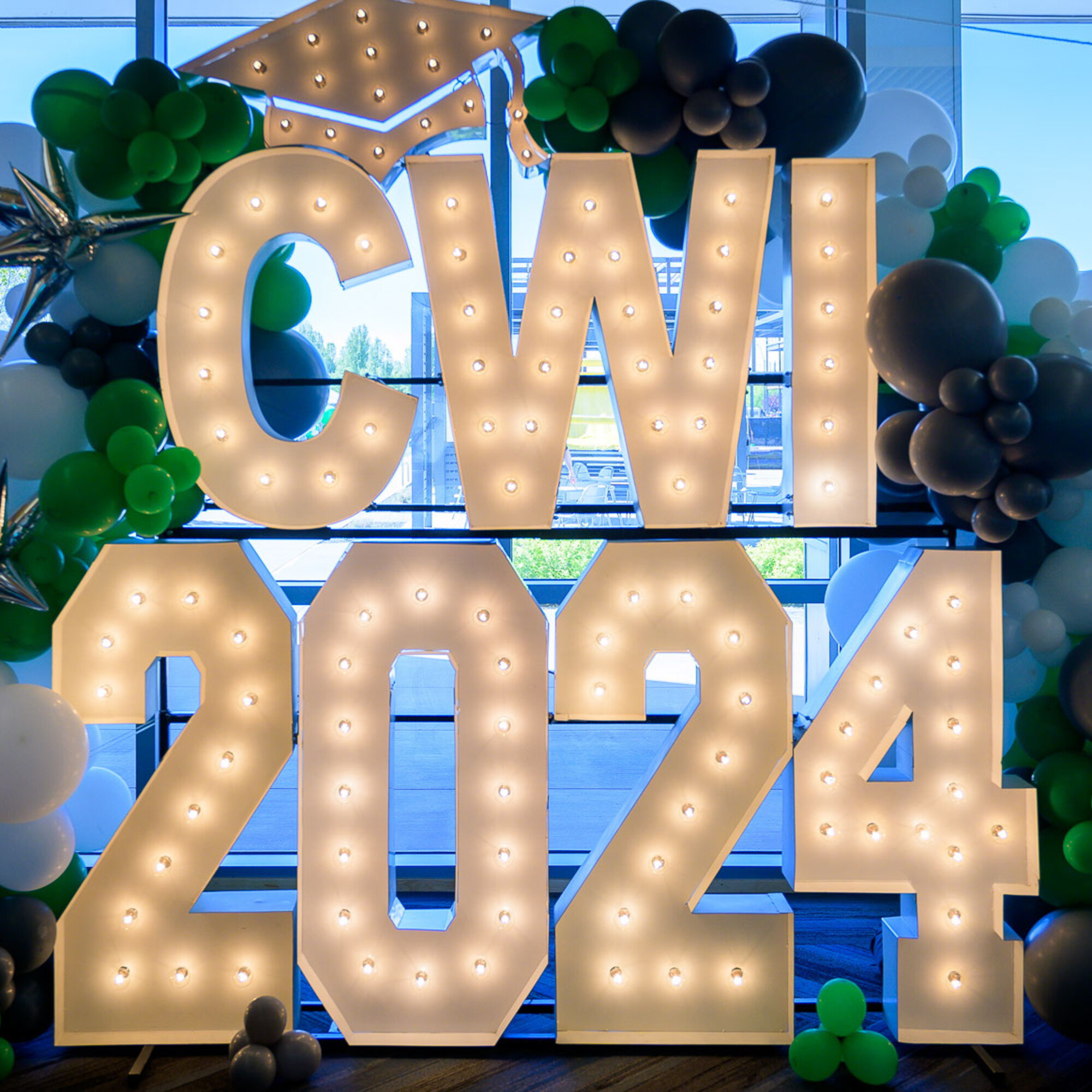 A display is pictured, comprised of large letters that say "CWI 2024" and are surrounded by balloons.
