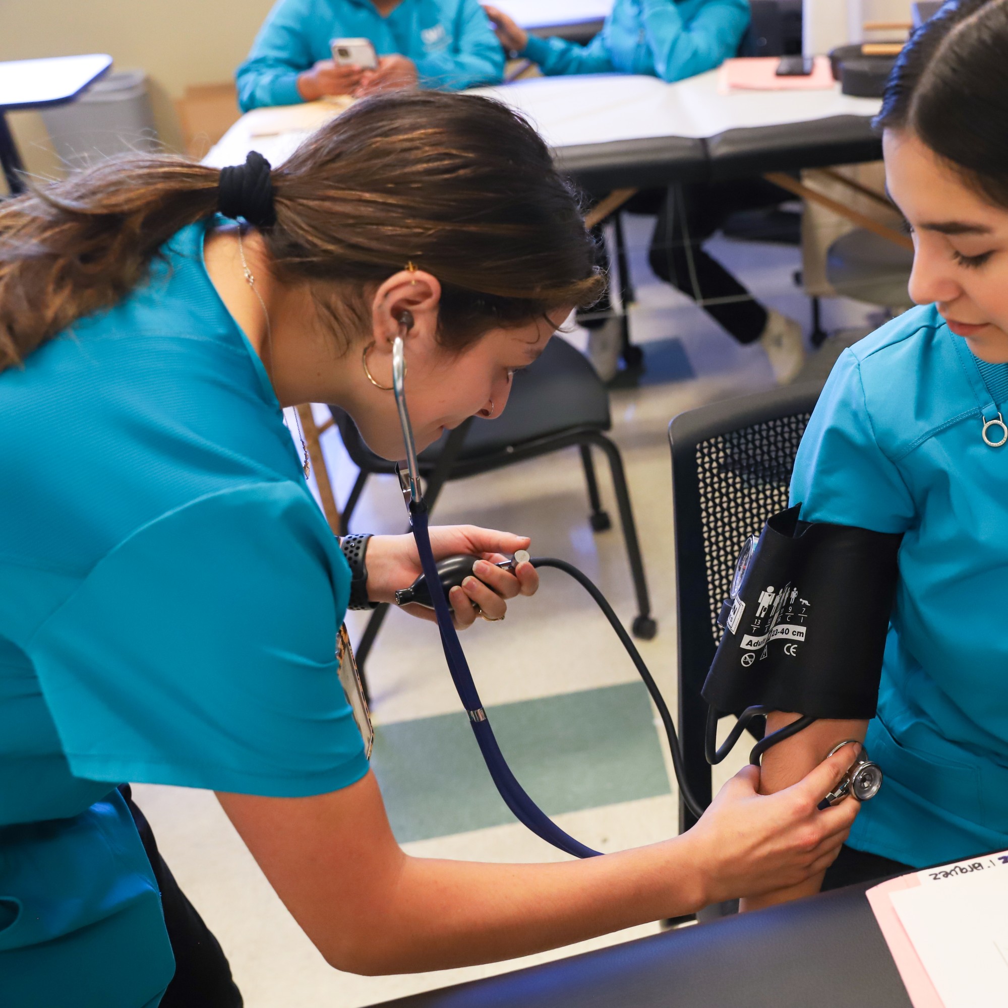Medical assistant students working together in lab
