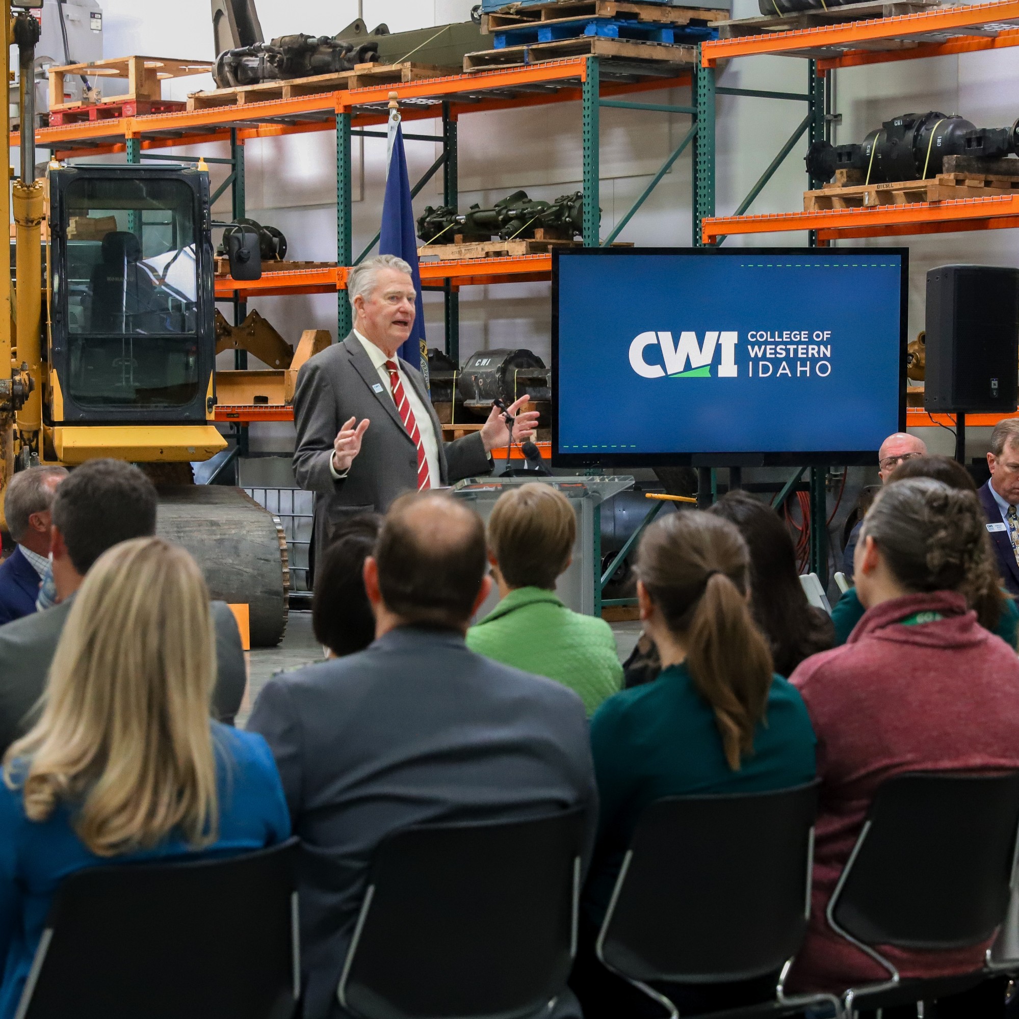 Governor Little speaking in front of audience at CWI