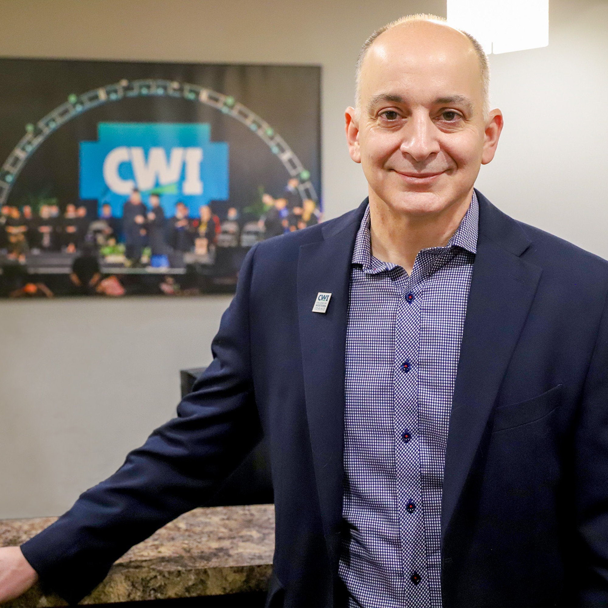 Kenneth Kline standing in front of desk and CWI picture
