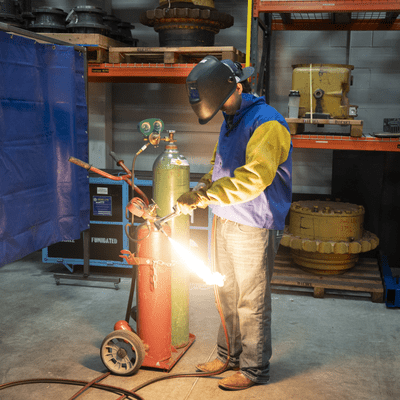 Person welding in a lab with a helmet on