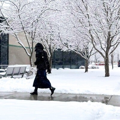 Student walking into the Ada County Campus Pintail Center in the snow