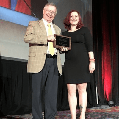 Rhonna Krouse accepting award at during the League for Innovation’s 2019 Conference in New York City.