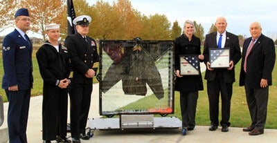 Veterans with Jacket in shadow box at Veterans Day event