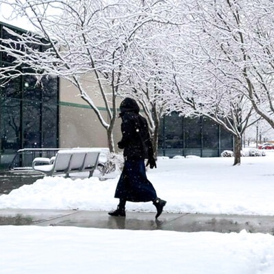 Student walking into the Ada County Campus Pintail Center in the snow