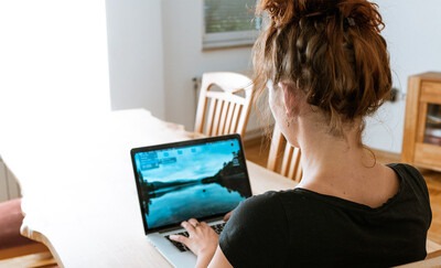 Woman on a laptop at her dining room table