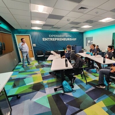 Students listen to a presentation in an Entrepreneur Lab.