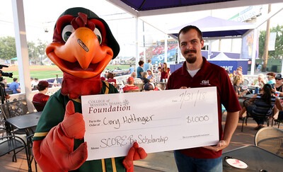 A #mightyCWI student receives a $1,000 scholarship during CWI Night at the Boise Hawks.