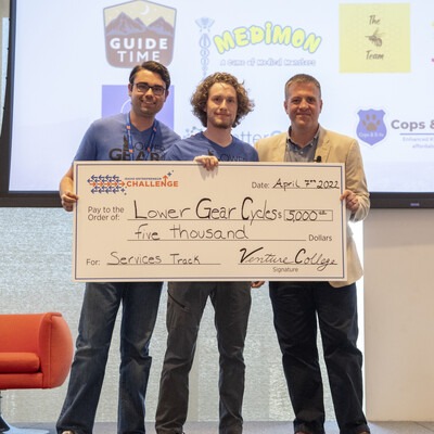 Lower Gear Cycles team accepting prize money on state at Idaho Entrepreneur Challenge