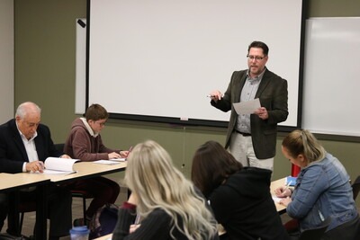Ryan Witt teaching in front of a class