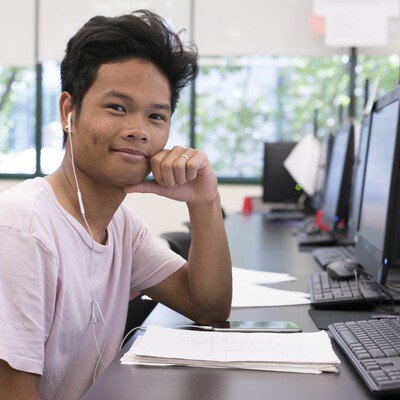 Student in computer lab with headphones in
