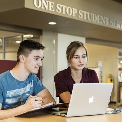 Staff assisting a student at One Stop Student Services
