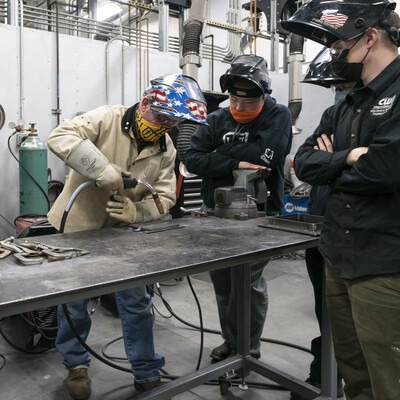 Students and faculty welding