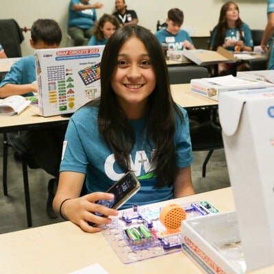 Smiling child working with electronics