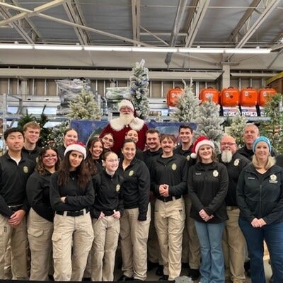 Group of people stand in store near Santa Claus