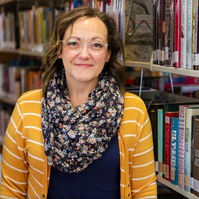 Autumn Brackley standing in front of book shelf