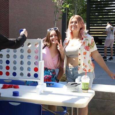 CWI students playing connect four outside