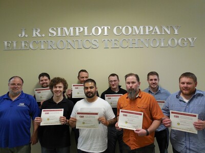 Group of students with FANUC Robotics as a Certified Education certificates.