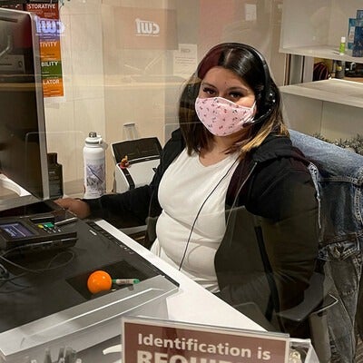 One Stop Student Services Representative at her desk on campus