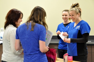 Dental Assisting students speak with visitors during the PACE event in 2015.