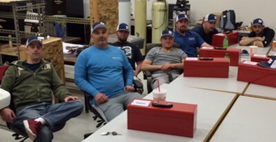 Plumbing Apprentices sitting at tables in a classroom