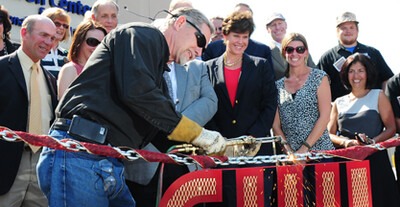 Randy Johnson cuts the ceremonial chain at the Micron Center for Professional Technical Education grand opening celebration.