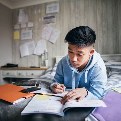 The image features a young student in his home environment implementing good study habits.