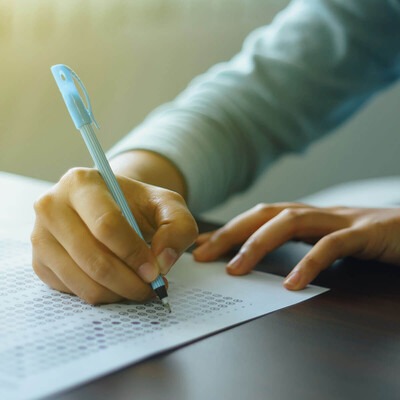 Image is a close-up of a student taking an exam.