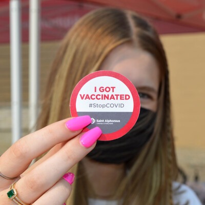 individual with a vaccination sticker