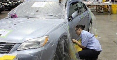 Student painting on car
