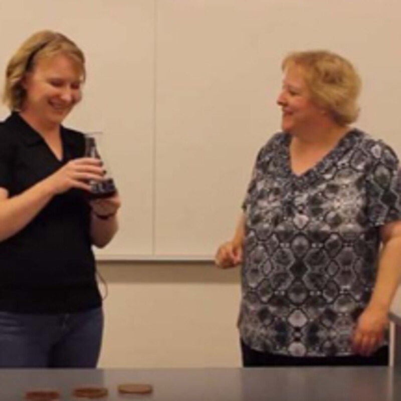 Two faculty members making agar