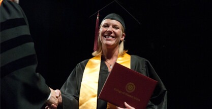 Student on stage at commencement