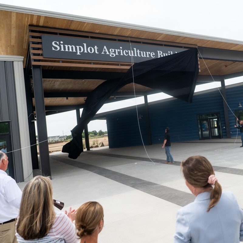 A new sign is unveiled on a building.