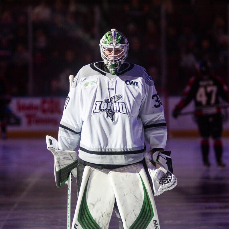 A hockey player stands on the ice.